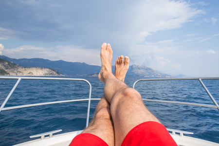 beautiful young woman enjoys relaxing on a yacht at seaの写真素材