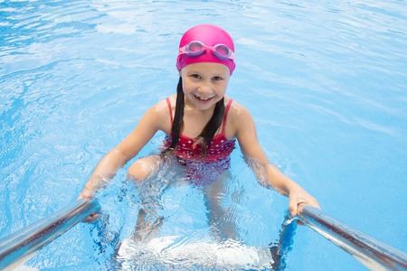 Portrait of little swimmer girl in swimming poolの写真素材
