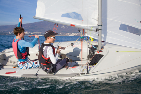 Team of two boys deftly managed to sail in the seaの写真素材