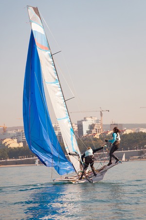 Team of two girls deftly managed to sail in the seaの写真素材
