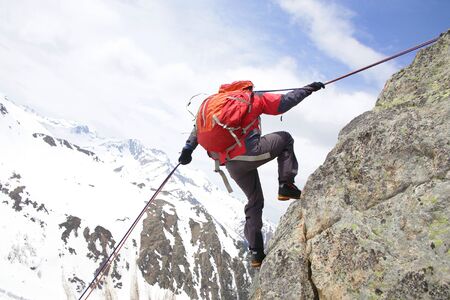 mountaineer  descends from the mountain in the background of the landscape of snowy mountains