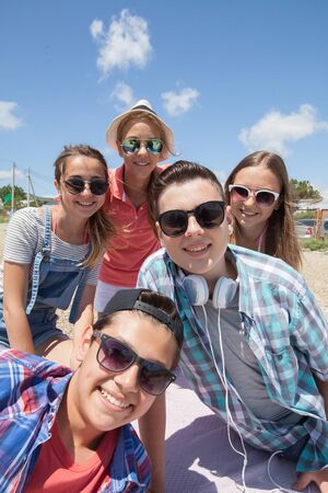 funny portrait of group of teenagers spending time togetherの写真素材