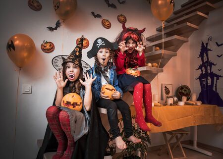 group of funny  children in costume celebrate together a halloween partyの写真素材
