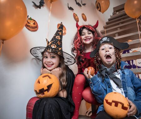group of funny  children in costume celebrate together a halloween partyの写真素材