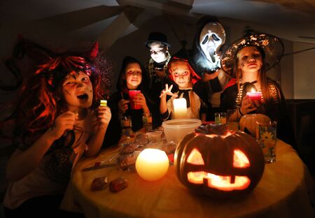 group of funny  children in costume celebrate together a halloween partyの写真素材