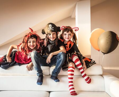 group of funny  children in costume celebrate together a halloween partyの写真素材