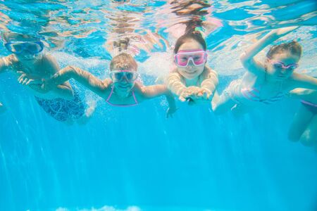 little kids play and  swimming  in pool  underwater.の写真素材