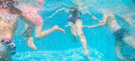 little kids play and  swimming  in pool  underwater.