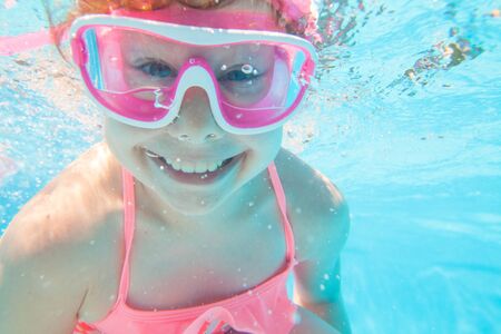 portrait of  little girl by the side of the poolの写真素材