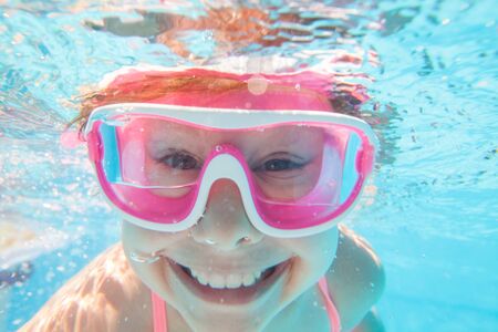 portrait of  little girl by the side of the poolの写真素材