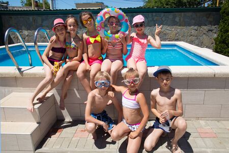 Portrait of group children playing in swimming  pool at the sea resortの写真素材