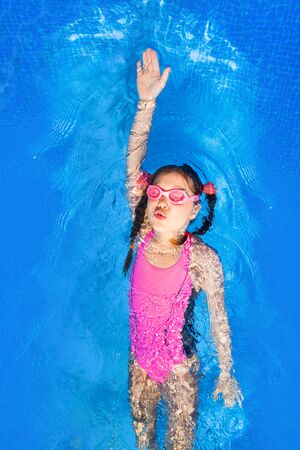 photo of little girl in swimming poolの写真素材