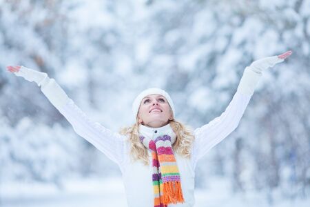 laughing young woman playing in the snowの写真素材
