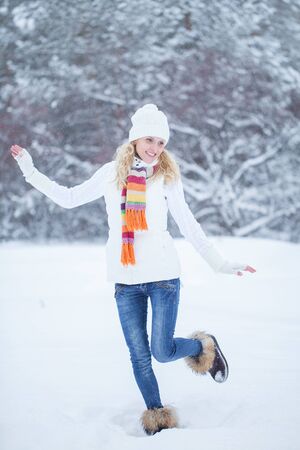 laughing young woman playing in the snowの写真素材
