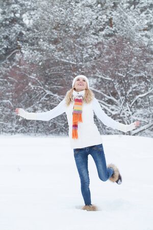 laughing young woman playing in the snowの写真素材