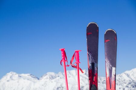 mountain skiing set standing in the snow against the backdrop of the beautiful snow-capped mountainsの写真素材