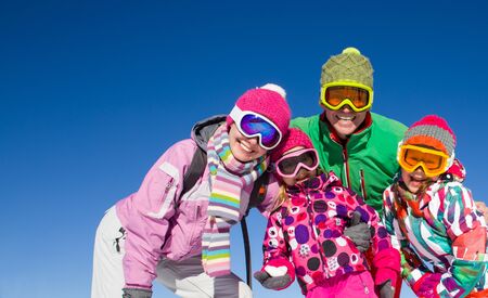 happy family in alpin ski equipment  at the ski resortの写真素材