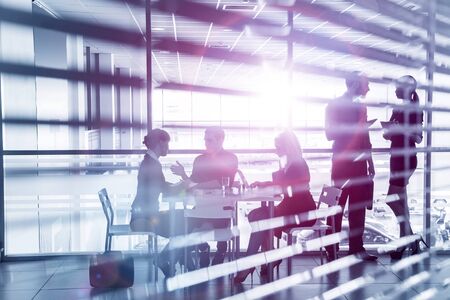 Group of silhouettes of businesspeople interacting  background business centreの写真素材
