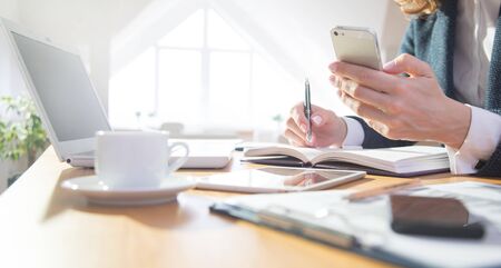 Hands of businesswoman  working with laptop and phone in officeの写真素材
