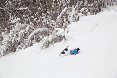 Young woman  snowboarders learning skates  in a ski resortの写真素材