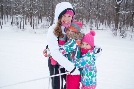 Portrait of a sporting family in equipment at a ski resortの写真素材