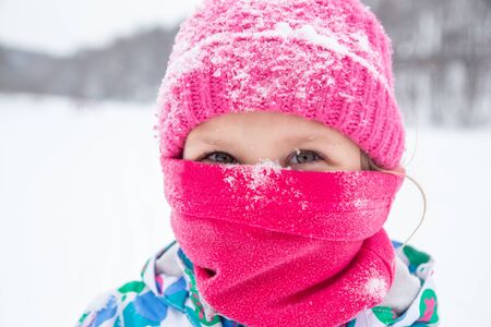 sporting little girl in equipment at a ski resortの写真素材