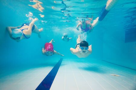 little kids play and  swimming  in pool  underwater.の写真素材
