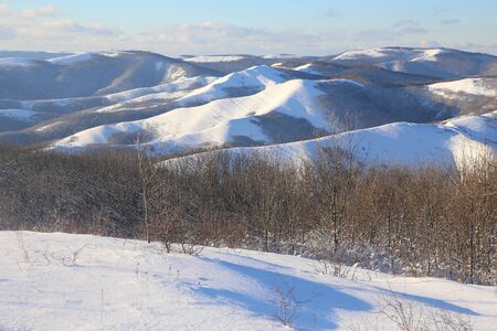 cold day in the snowy winter small mountainsの写真素材