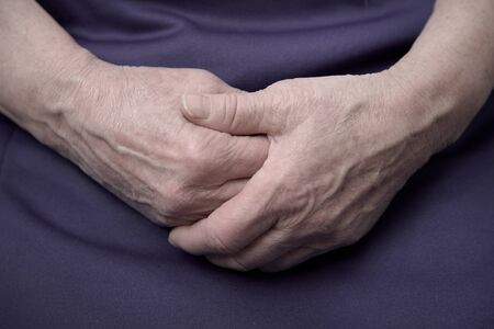 wrinkled hands of an old woman close-upの写真素材