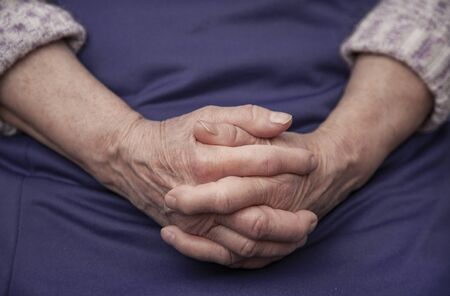 wrinkled hands of an old woman close-upの写真素材