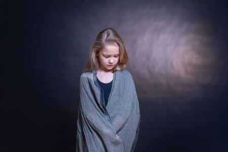 little girl angel with wings-arms on a dark backgroundの写真素材