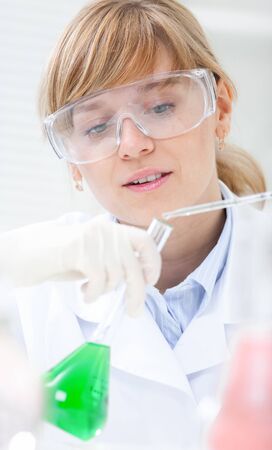 Medical or scientific researcher or doctor using looking at a solution in a laboratoryの写真素材