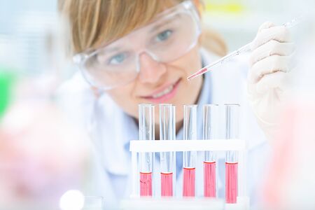 Medical or scientific researcher or doctor using looking at a solution in a laboratoryの写真素材