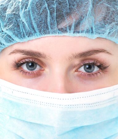 Face of nurse in sterile mask looking at cameraの写真素材