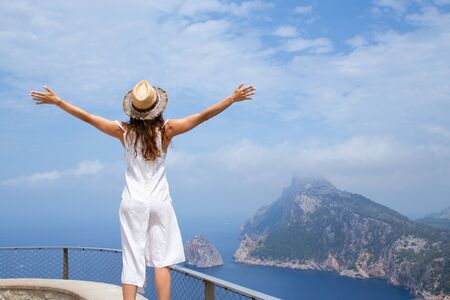 young woman enjoys beautiful see on the sea in summer vacationの写真素材