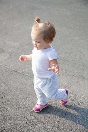 little one year old girl takes the first stepsの写真素材