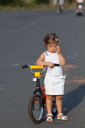 little girl learning skate on bikeの写真素材