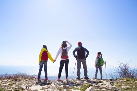 family with two kids have hiking  through the mountainsの写真素材