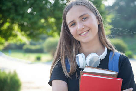 young girl student on a background of green parkの写真素材