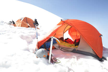 tourist tent camp in the snow moutainsの写真素材