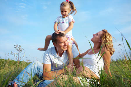 Family with mother expecting having happy time outdoorsの写真素材