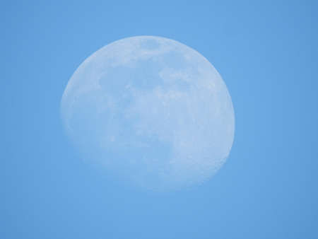 full moon in the blue sky during the day