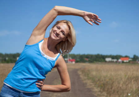 woman in seriors age doing yoga outdoorsの写真素材