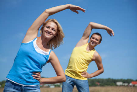 Couple elderly people doing yoga outdoorsの写真素材