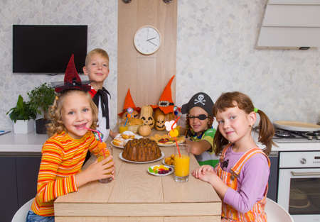 group of funny children in costume celebrate together a halloween partyの写真素材