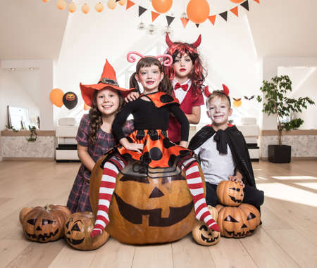 group of funny children in costume celebrate together a halloween partyの写真素材