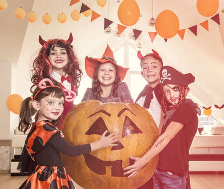 group of funny children in costume celebrate together a halloween partyの写真素材
