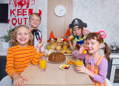 group of funny children in costume celebrate together a halloween partyの写真素材