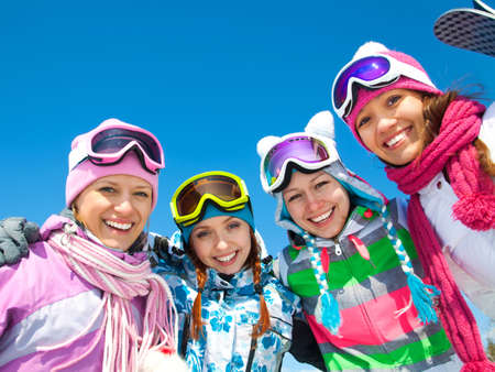 Group of girlfriands on ski holiday in mountainsの写真素材