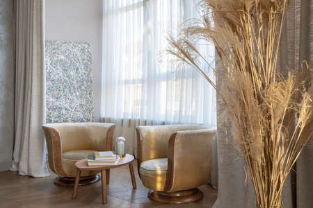 modern interior of bedroom with armchairs and textiles decorの写真素材